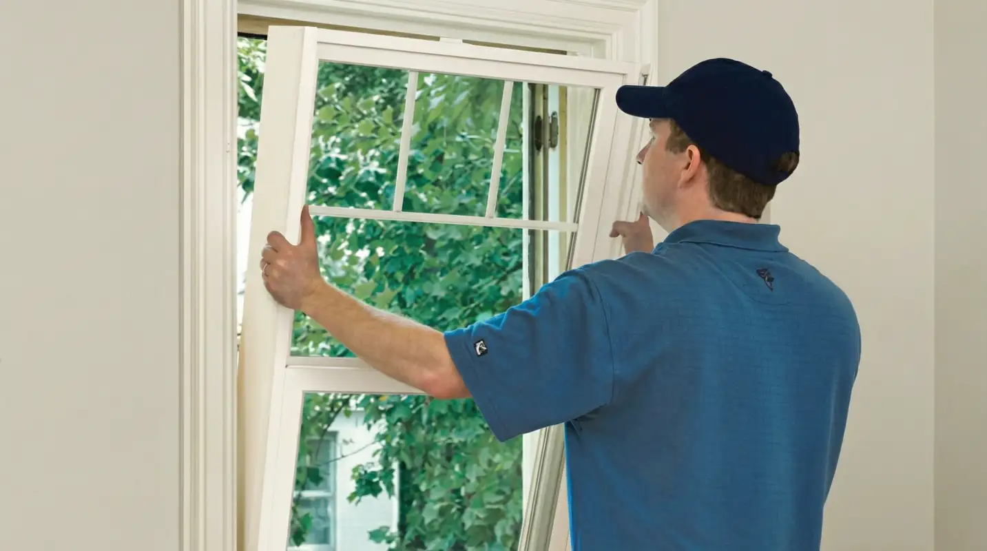 Professional contractors performing a residential window insulation and replacement service in Minneapolis, MN